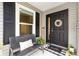 Inviting front porch with a comfortable bench and a welcoming door adorned with a decorative wreath at 5726 Leboeuf Ln, The Villages, FL 32163