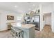 Bright kitchen featuring stainless steel appliances, and a spacious island with barstool seating at 5726 Leboeuf Ln, The Villages, FL 32163