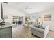 Bright living room features light wood floors, and sliding doors leading to the screened lanai at 5726 Leboeuf Ln, The Villages, FL 32163
