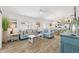 Spacious living room seamlessly blends into an open kitchen with ample seating and natural light at 5726 Leboeuf Ln, The Villages, FL 32163