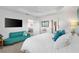 Comfortable main bedroom features a sitting area, tray ceiling, and ensuite bathroom at 5726 Leboeuf Ln, The Villages, FL 32163