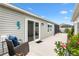 Outdoor patio area with sliding glass doors and view of the manicured backyard at 5726 Leboeuf Ln, The Villages, FL 32163