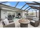 Relaxing covered patio area with hot tub, seating, dining, and outdoor television at 5726 Leboeuf Ln, The Villages, FL 32163
