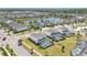 Aerial view of a suburban neighborhood with community pools and a scenic pond at 598 Marcello Blvd, Kissimmee, FL 34746