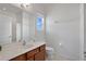 Bright bathroom featuring a wood vanity, white countertop, and a large mirror at 598 Marcello Blvd, Kissimmee, FL 34746
