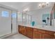 Well-lit bathroom with double sink vanity, frameless shower, and neutral color scheme at 598 Marcello Blvd, Kissimmee, FL 34746