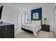 Comfortable bedroom with a dark blue accent wall, soft lighting, and neutral colors at 598 Marcello Blvd, Kissimmee, FL 34746