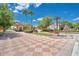 Inviting community entrance with lush landscaping, mature trees, and decorative pavers at 598 Marcello Blvd, Kissimmee, FL 34746