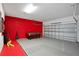 Spacious garage with a pool table, red accent wall, and ample room for parking at 598 Marcello Blvd, Kissimmee, FL 34746