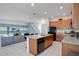 Well-lit kitchen featuring modern appliances, breakfast bar and seamless access to the living room at 598 Marcello Blvd, Kissimmee, FL 34746