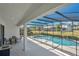 Covered patio beside screened-in pool area, offering privacy and outdoor relaxation at 598 Marcello Blvd, Kissimmee, FL 34746
