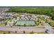 Aerial view of the tennis courts in a community setting with lush greenery surrounding the area at 6342 Whittle Ct, The Villages, FL 32163