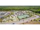 An aerial shot of the community's amenities, including tennis and bocce ball courts, and a pool at 6342 Whittle Ct, The Villages, FL 32163