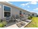 Charming back patio area featuring comfortable seating and lush landscaping at 6342 Whittle Ct, The Villages, FL 32163