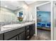 View of bathroom with double sinks, granite countertops, walk-in shower and bedroom view at 6342 Whittle Ct, The Villages, FL 32163