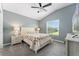 Comfortable bedroom featuring a ceiling fan, carpeted floors and a large window for natural light at 6342 Whittle Ct, The Villages, FL 32163