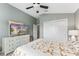 Bedroom featuring a ceiling fan, mounted television, and an attached closet at 6342 Whittle Ct, The Villages, FL 32163