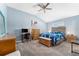 Bright bedroom features vaulted ceiling, ceiling fan, natural light and beautiful wood furniture at 6342 Whittle Ct, The Villages, FL 32163