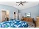 This bedroom is spacious and leads to a bathroom and has a dresser with a vanity mirror at 6342 Whittle Ct, The Villages, FL 32163