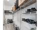 Walk-in closet with wire shelving filled with clothes, containers, luggage, and shoes at 6342 Whittle Ct, The Villages, FL 32163