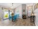 Bright dining area with blue table, chairs, and views of the front door at 6342 Whittle Ct, The Villages, FL 32163