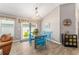 Bright dining area with blue table, chairs, and views of the outside at 6342 Whittle Ct, The Villages, FL 32163