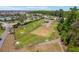 Community dog park featuring grassy areas, shaded benches, and a secure fence for pets at 6342 Whittle Ct, The Villages, FL 32163