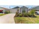 Charming single story home with blue and gray accents, attached garage, and well-kept landscaping at 6342 Whittle Ct, The Villages, FL 32163