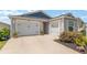 Charming home featuring a three-car garage, well-kept landscaping, and excellent curb appeal at 6342 Whittle Ct, The Villages, FL 32163