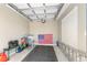 Clean, single-car garage with neutral walls, concrete floor, storage shelves, and bright natural light at 6342 Whittle Ct, The Villages, FL 32163