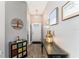 Inviting hallway with decorative accents and a view of the front door at 6342 Whittle Ct, The Villages, FL 32163