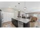 Open kitchen concept with an island, connecting the dining and living areas at 6342 Whittle Ct, The Villages, FL 32163