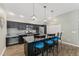 Stylish kitchen boasts an island with barstool seating and sleek appliances at 6342 Whittle Ct, The Villages, FL 32163