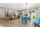 Bright and airy living room featuring vaulted ceilings, modern lighting, and an open-concept design at 6342 Whittle Ct, The Villages, FL 32163