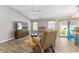 Open living room with wood floors, neutral walls, a ceiling fan, and views into the dining area at 6342 Whittle Ct, The Villages, FL 32163