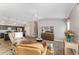 Spacious open-concept living space with wood floors and views into kitchen with breakfast bar at 6342 Whittle Ct, The Villages, FL 32163