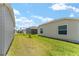 Spacious side yard with green grass, offering ample space for outdoor enjoyment at 6342 Whittle Ct, The Villages, FL 32163