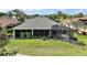 A spacious backyard features a screened patio and a luxurious hot tub for outdoor enjoyment and relaxation at 685 Winifred Way, The Villages, FL 32162