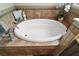 The bathroom features a tiled surround soaking tub with decorative fixtures and ample space to relax at 685 Winifred Way, The Villages, FL 32162