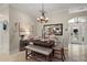 Dining room features a chandelier, mirror, and decorative wall art at 685 Winifred Way, The Villages, FL 32162