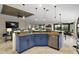 Open-concept kitchen with blue cabinets and granite countertops at 685 Winifred Way, The Villages, FL 32162