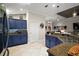 Modern kitchen with blue cabinets, stainless steel appliances, and granite countertops at 685 Winifred Way, The Villages, FL 32162