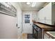 Practical laundry room featuring a washer, dryer, and storage cabinets at 685 Winifred Way, The Villages, FL 32162