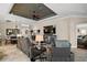 Open-concept living room with tile flooring, large TV, and cozy furnishings throughout at 685 Winifred Way, The Villages, FL 32162