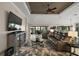 Cozy living room features a comfortable seating arrangement, a coffee table, and a modern television at 685 Winifred Way, The Villages, FL 32162
