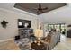 Comfortable living room featuring a ceiling fan and sliding glass doors to the backyard at 685 Winifred Way, The Villages, FL 32162