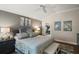 The main bedroom is inviting, featuring wood floors, soothing paint, and decorative art at 685 Winifred Way, The Villages, FL 32162