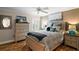 This is a relaxing main bedroom featuring a neutral color palette, light wood floors, and plenty of pillows at 685 Winifred Way, The Villages, FL 32162