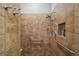 This tiled shower features a built-in shower bench, safety grab bars, and niche for toiletries at 685 Winifred Way, The Villages, FL 32162