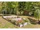 Beautifully landscaped backyard featuring tiered garden beds bursting with colorful flowers at 7115 Lake Ola Dr, Mount Dora, FL 32757